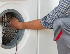 Dryer repair technician diagnosing and servicing a clothes dryer in Ann Arbor, MI
