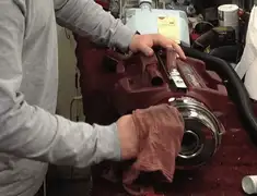 Vacuum repair technician cleaning and servicing a vacuum motor in Ann Arbor, MI
