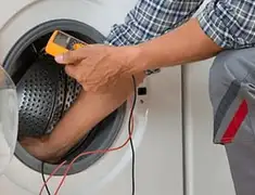 Washing machine repair technician testing a front-load washer with diagnostic tools in Ann Arbor, MI